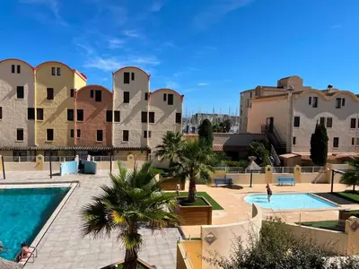 a resort with a swimming pool and some buildings at Gruissan: T2 Cabine, Piscine, Parking, Centre, 4/5 pers, Petit Budget - FR-1-796-3 in Gruissan