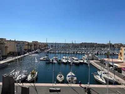 a marina filled with lots of boats in the water at Gruissan: T2 Cabine, Piscine, Parking, Centre, 4/5 pers, Petit Budget - FR-1-796-3 in Gruissan