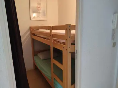 a wooden bunk bed in a small room at Gruissan: T2 Cabine, Piscine, Parking, Centre, 4/5 pers, Petit Budget - FR-1-796-3 in Gruissan