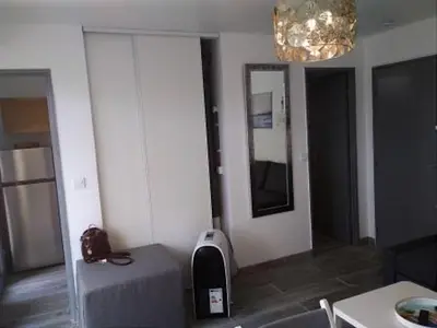 a living room with a sink and a mirror at Gruissan - Studio rénové climatisé 2/3 pers, parking sécurisé, à 50m de la plage du Grazel - FR-1-796-16 in Gruissan