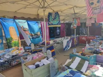 a tent filled with lots of different types of merchandise at Gruissan - Studio rénové climatisé 2/3 pers, parking sécurisé, à 50m de la plage du Grazel - FR-1-796-16 in Gruissan