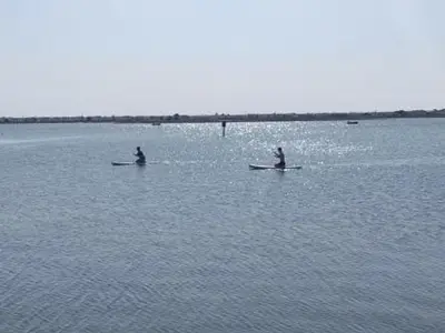 two people are sitting on boats in the water at Gruissan - Studio rénové climatisé 2/3 pers, parking sécurisé, à 50m de la plage du Grazel - FR-1-796-16 in Gruissan