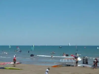a group of people in the water at the beach at Gruissan - Studio rénové climatisé 2/3 pers, parking sécurisé, à 50m de la plage du Grazel - FR-1-796-16 in Gruissan