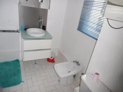 a small bathroom with a sink and a toilet at Gruissan: T3, 4 Pers, Piscine, Parking, Proche Commerce, Environnement Calme, Accès Plage - FR-1-796-14 in Gruissan
