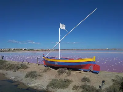 a boat on the beach with a flag on it at Gruissan - À 2 Pas de la Plage - Studio Cabine pour 4 - Parking Sécurisé - FR-1-796-15 in Gruissan
