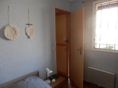 a bedroom with a bed and a window at T2 RDC avec Terrasse, Piscine & Parking - Proche Vieux Village de Gruissan - FR-1-796-20 in Gruissan