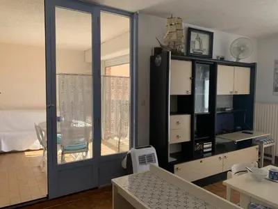 a living room with a large sliding glass door at T2 Confort Centre Port 4 Pers - Clim - Parking - Ascenseur - FR-1-796-25 in Gruissan