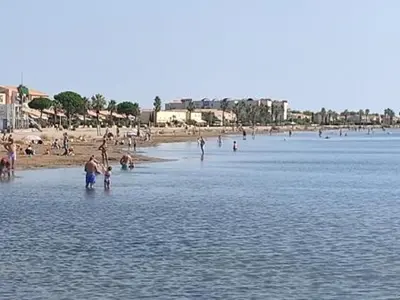 a group of people standing in the water at a beach at Gruissan - T2 Mezzanine Climatisé Proche Plage - 5/6 Pers - Parking Privé - Tout Équipé - FR-1-796-23 in Gruissan