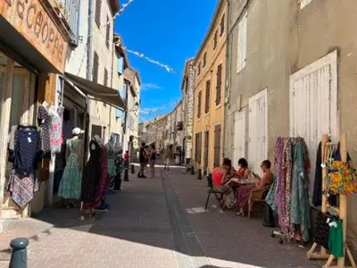 a group of people sitting in chairs on a street at Gruissan - T2 Mezzanine Climatisé Proche Plage - 5/6 Pers - Parking Privé - Tout Équipé - FR-1-796-23 in Gruissan
