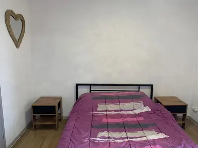 a bedroom with a bed with a purple comforter and two tables at Gruissan - T2 Mezzanine Climatisé Proche Plage - 5/6 Pers - Parking Privé - Tout Équipé - FR-1-796-23 in Gruissan