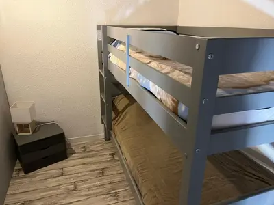 a bunk bed in a room with a wooden floor at Gruissan: T2 Mezzanine 6 pers, proche plage, parking privé - FR-1-796-35 in Gruissan