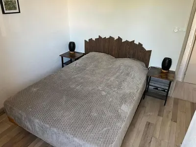 a bedroom with a large bed with two night stands at Gruissan: T2 Mezzanine 6 pers, proche plage, parking privé - FR-1-796-35 in Gruissan
