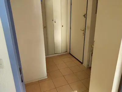 a hallway with white doors and a tile floor at Gruissan: T2 Spacieux 4/5 Pers, Proche Plage Grazel, Parking Privé - FR-1-796-34 in Gruissan