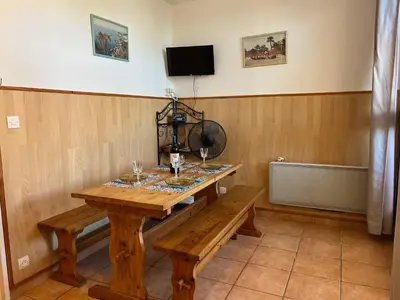 a wooden table with wine glasses on top of it at Studio Familial Piscine, Parking, Proche Plage - Idéal 4 pers, Budget Serré, Gruissan - FR-1-796-58 in Gruissan