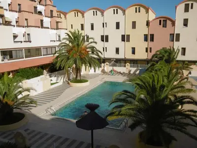 an overhead view of a pool with palm trees and buildings at Studio Familial Piscine, Parking, Proche Plage - Idéal 4 pers, Budget Serré, Gruissan - FR-1-796-58 in Gruissan