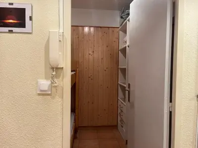 a hallway with a door to a closet with a phone at Studio Familial Piscine, Parking, Proche Plage - Idéal 4 pers, Budget Serré, Gruissan - FR-1-796-58 in Gruissan