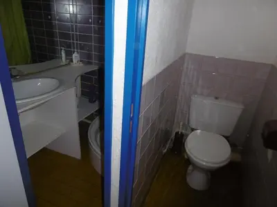 a small bathroom with a toilet and a sink at **Gruissan - T2 Cabine Mezzanine - Côté Village - 6 pers - Parking Privé - Proche Plages** - FR-1-796-63 in Gruissan