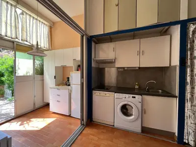 a kitchen with a washer and dryer in a room at **Gruissan - T2 Cabine Mezzanine - Côté Village - 6 pers - Parking Privé - Proche Plages** - FR-1-796-63 in Gruissan