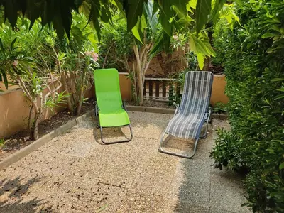 two green chairs sitting next to each other at **Gruissan - T2 Cabine Mezzanine - Côté Village - 6 pers - Parking Privé - Proche Plages** - FR-1-796-63 in Gruissan