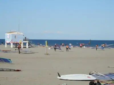 a group of people on a beach with the ocean at Gruissan Studio Vue Mer 2/3 Pers à 50m Plage Grazel, Parking Sécurisé - FR-1-796-47 in Gruissan