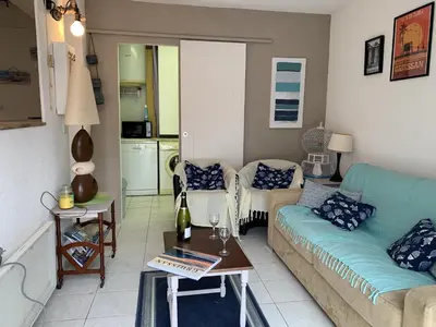 a living room with a couch and a table at Villa Confortable 6 Pers. Climatisée, Proche Plage du Grazel, Calme, Tout Équipée, Stationnement Inclus - FR-1-796-71 in Gruissan