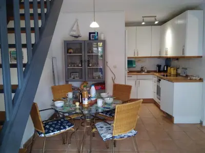 a kitchen with a table and chairs in a room at Villa Confortable 6 Pers. Climatisée, Proche Plage du Grazel, Calme, Tout Équipée, Stationnement Inclus - FR-1-796-71 in Gruissan