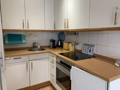 a small kitchen with white cabinets and a sink at Villa Confortable 6 Pers. Climatisée, Proche Plage du Grazel, Calme, Tout Équipée, Stationnement Inclus - FR-1-796-71 in Gruissan