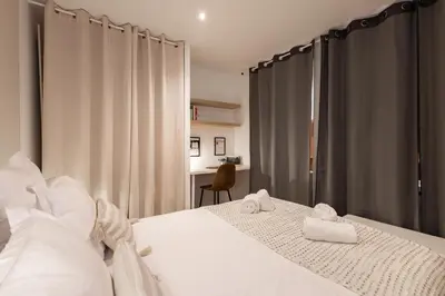 a bedroom with a bed with two towels on it at L'Occitane - Grand Studio Chaleureux en Hyper centre in Castres