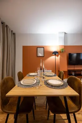 a wooden table with chairs and a dining room at L'Occitane - Grand Studio Chaleureux en Hyper centre in Castres