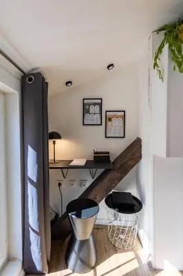 a staircase in a room with a desk at Le Sunny - Cocon Lumineux au Cœur de Castres in Castres