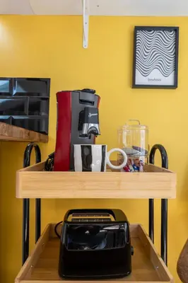 a table with a coffee maker on top of it at Le Sunny - Cocon Lumineux au Cœur de Castres in Castres