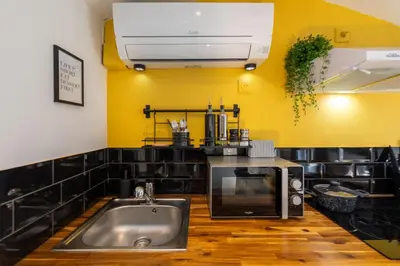 a kitchen with a sink and a microwave at Le Sunny - Cocon Lumineux au Cœur de Castres in Castres