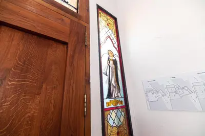 a stained glass window next to a wooden door at Appartement du Cloitre 1er in Narbonne