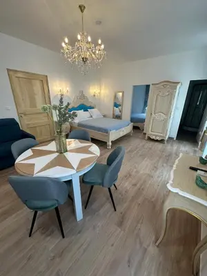 a room with a table and a bed and a bedroom at Appartement du Cloitre 1er in Narbonne