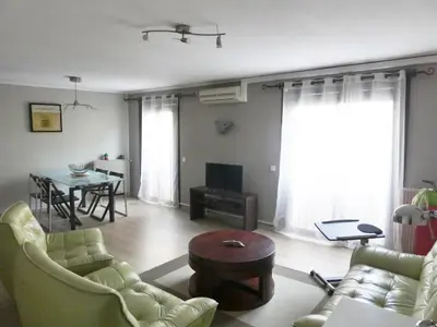 a living room with a couch and a table at La Courtine, centre historique Narbonne in Narbonne