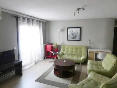 a living room with a couch and a table at La Courtine, centre historique Narbonne in Narbonne