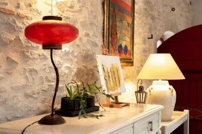 a red lamp sitting on top of a table with a lamp at Loft centre-ville Parking, clim, wifi in Carcassonne