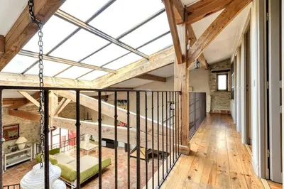 a large room with a glass ceiling and wooden floors at Loft centre-ville Parking, clim, wifi in Carcassonne
