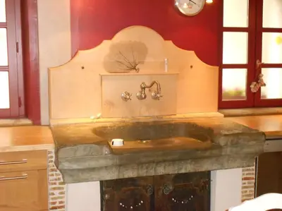 a bathroom with a stone sink in a room at Loft centre-ville Parking, clim, wifi in Carcassonne