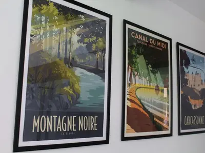 three framed posters hanging on a wall at Le Moulin, avec parc, piscine, au cœur du village in Villegly