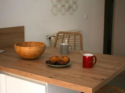a table with a plate of food and a cup of coffee at Le Moulin, avec parc, piscine, au cœur du village in Villegly