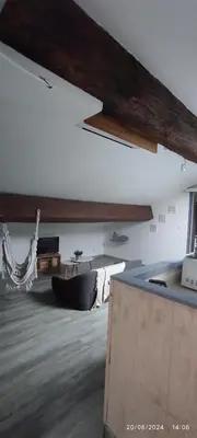 a living room with a couch and a table at Sous les toits in Narbonne