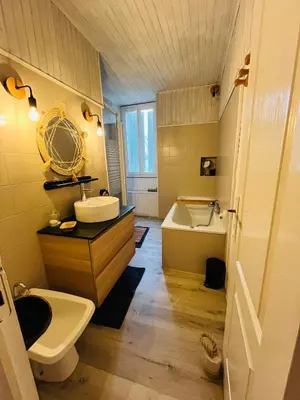 a bathroom with a sink and a toilet and a tub at Maison de village in Peyriac-Minervois