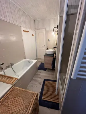 a bathroom with a bath tub and a sink at Maison de village in Peyriac-Minervois
