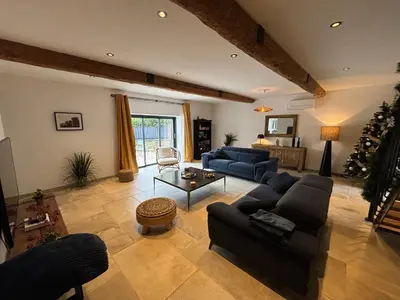 a large living room with couches and a christmas tree at La Vade in Carcassonne