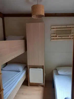 a room with two bunk beds and a desk at Chalet Zen in Vaudreuille