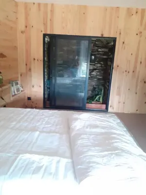 a bedroom with a white bed and a window at Au Grand Mûrier in Roquefère