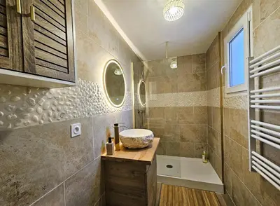 a bathroom with a sink and a bath tub at Tout confort ! Balnéo, Sauna, Cinéma, Climatisation, Parking, WiFi in Carcassonne