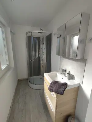 a white bathroom with a sink and a shower at Au coeur de l'occitanie in Cuq