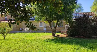 a house with a tree in the yard at Au coeur de l'occitanie in Cuq
